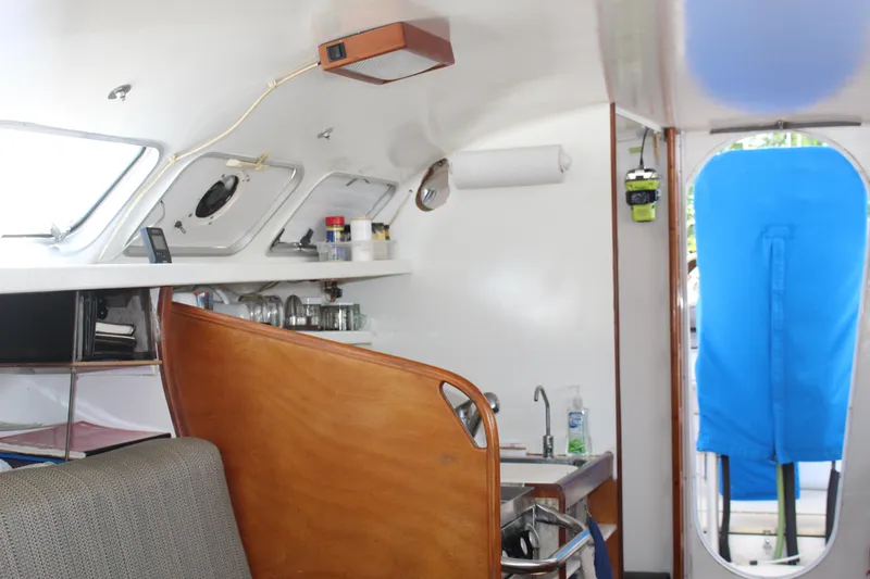 Panta Rhei Yacht Photos Pics Interior of 2012 Custom Roake 50 yacht with modern kitchen and seating area.