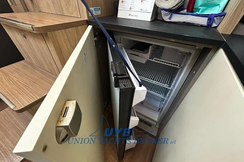  Yacht Photos Pics 2015 Cranchi M 44 HT yacht interior with open mini fridge in cabin.