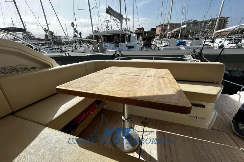 Yacht Photos Pics Luxurious 2015 Cranchi M 44 HT yacht interior with wooden table and seating area.