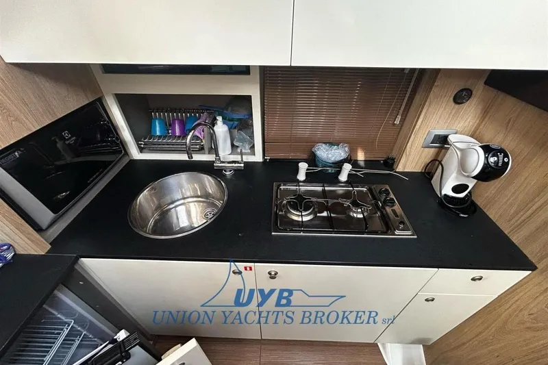  Yacht Photos Pics Modern kitchen in 2015 Cranchi M 44 HT yacht with sink, stove, and coffee maker.