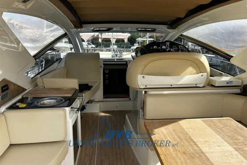  Yacht Photos Pics Interior of 2015 Cranchi M 44 HT yacht with beige seating and compact kitchenette.