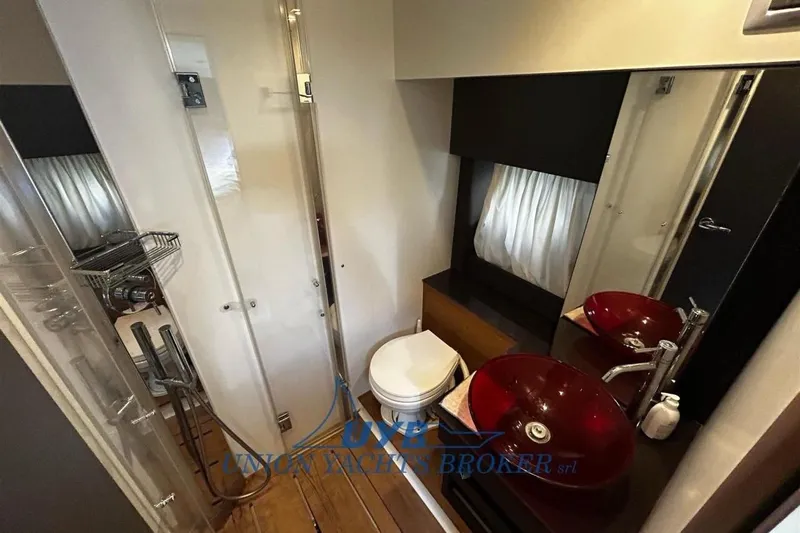  Yacht Photos Pics Luxurious bathroom in 2015 Cranchi M 44 HT yacht with modern fixtures and red vessel sink.