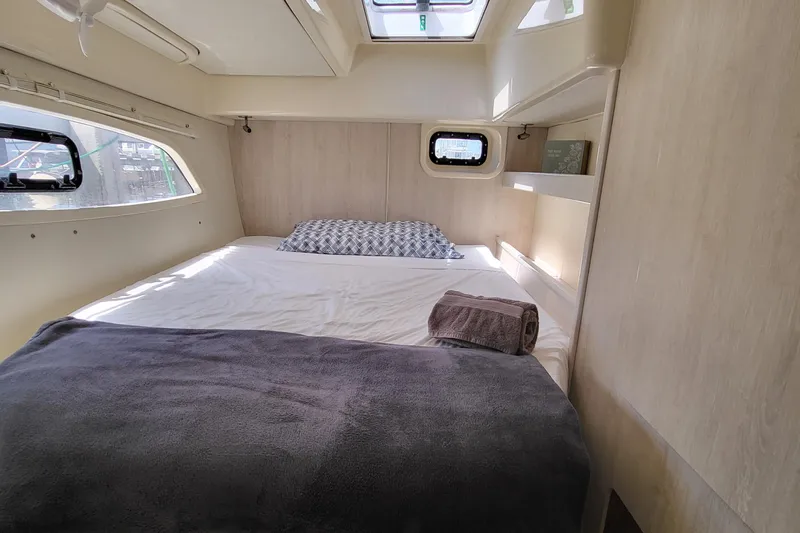 Ohana Yacht Photos Pics Interior of a 2016 Leopard 44 yacht, bedroom with bed and windows.
