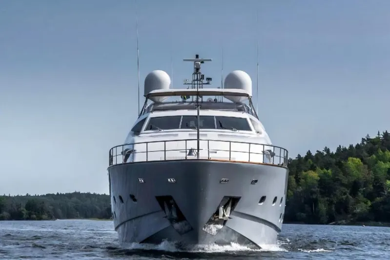 Queen Of Sheba Yacht Photos Pics Front view of 2006 Ferretti Yachts 112 Custom Line on water, surrounded by trees.