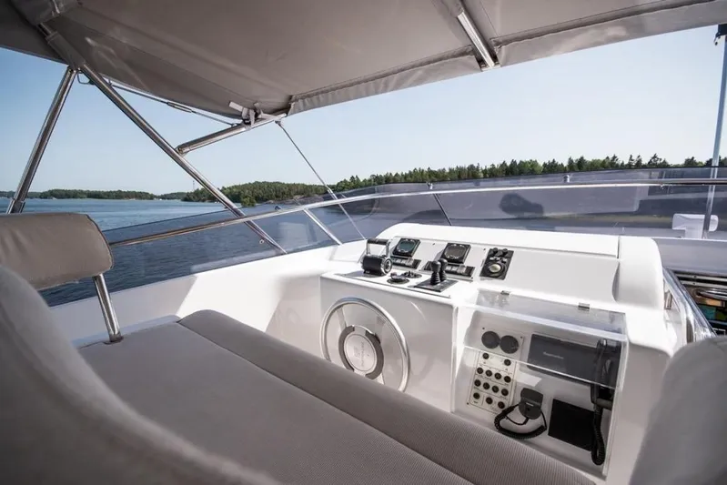 Queen Of Sheba Yacht Photos Pics Helm of 2006 Ferretti Yachts 112 Custom Line, featuring modern navigation equipment and serene water view.