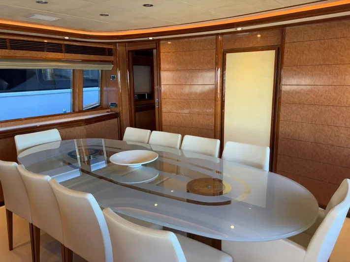 Queen Of Sheba Yacht Photos Pics Luxurious dining area on 2006 Ferretti Yachts 112 Custom Line, featuring elegant wood paneling and modern decor.