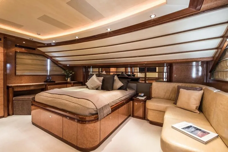 Queen Of Sheba Yacht Photos Pics Luxurious bedroom interior of 2006 Ferretti Yachts 112 Custom Line, featuring elegant wood finishes.