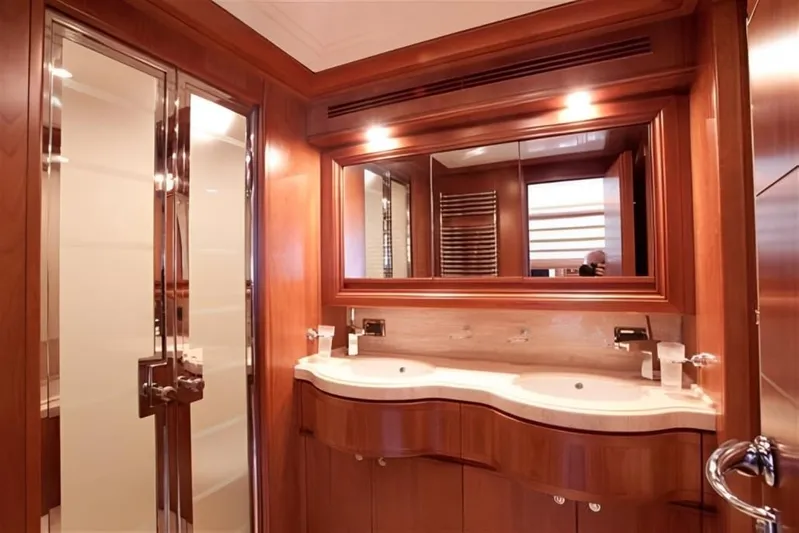 Queen Of Sheba Yacht Photos Pics Luxurious bathroom in 2006 Ferretti Yachts 112 Custom Line with dual sinks and elegant wood finish.