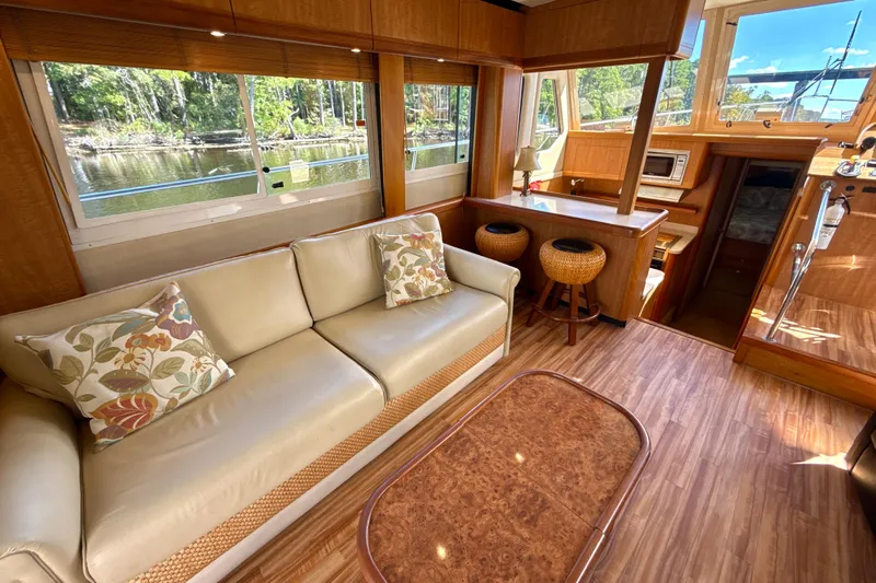 Blue Note Yacht Photos Pics Luxurious interior of 2007 Mainship 430 Trawler with elegant wood finish and comfortable seating.