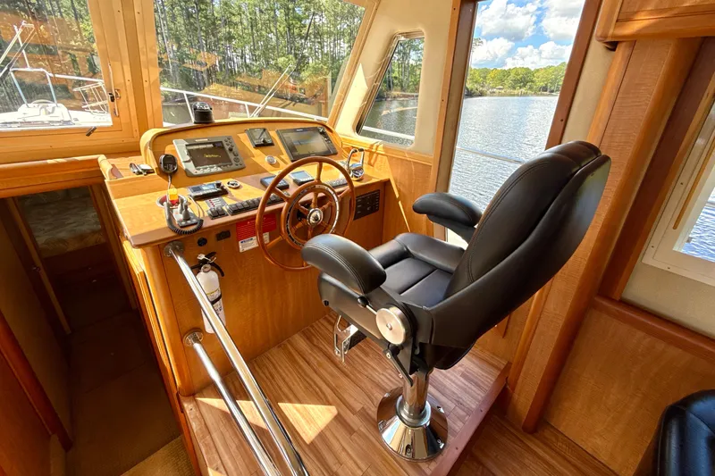Blue Note Yacht Photos Pics 2007 Mainship 430 Trawler helm with leather captain's chair and navigation equipment.