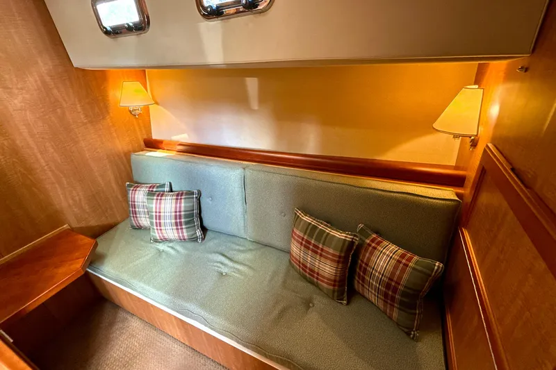 Blue Note Yacht Photos Pics Cozy interior of 2007 Mainship 430 Trawler with plaid cushions and warm lighting.