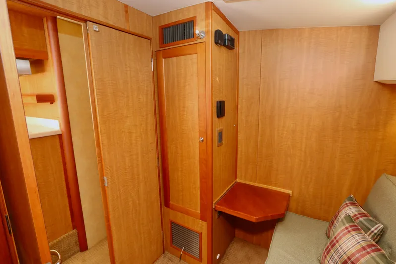 Blue Note Yacht Photos Pics 2007 Mainship 430 Trawler interior with wood paneling, foldable table, and cozy seating area.