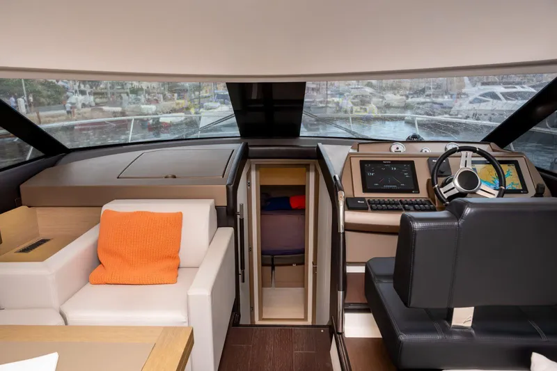 Yacht Photos Pics Luxurious interior of 2019 Prestige 500 yacht with modern helm and seating area.