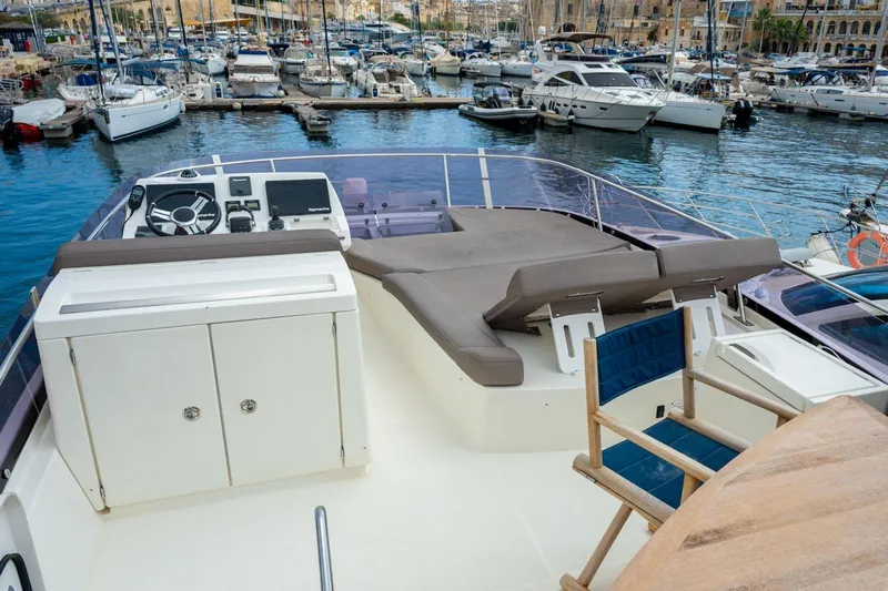  Yacht Photos Pics 2019 Prestige 500 yacht deck with seating, steering, and marina view.