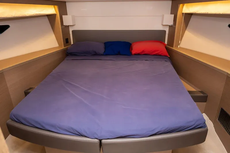  Yacht Photos Pics Luxurious cabin interior of 2019 Prestige 500 yacht with cozy bed and colorful pillows.