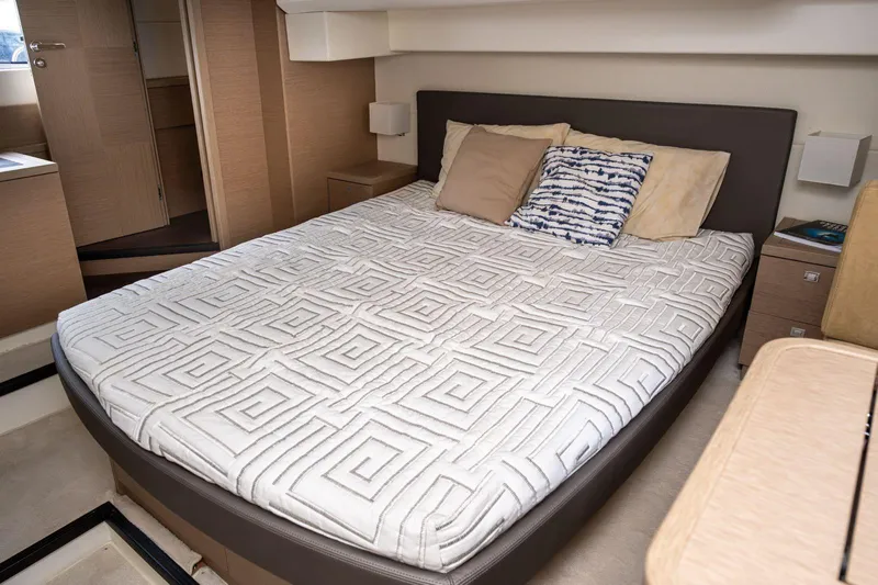  Yacht Photos Pics Luxurious bedroom interior of 2019 Prestige 500 yacht with modern bedding.