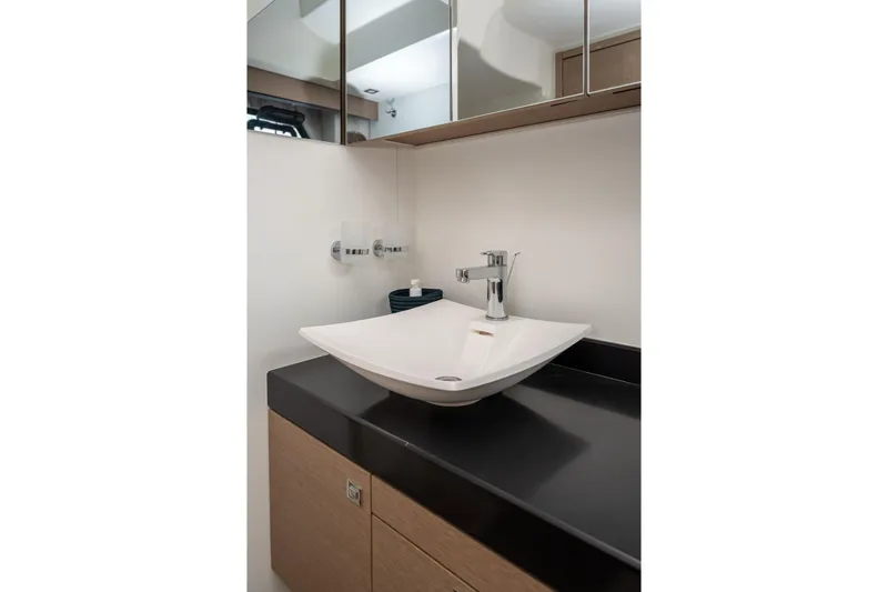  Yacht Photos Pics Modern bathroom sink in 2019 Prestige 500 yacht, featuring sleek design and mirrored cabinets.