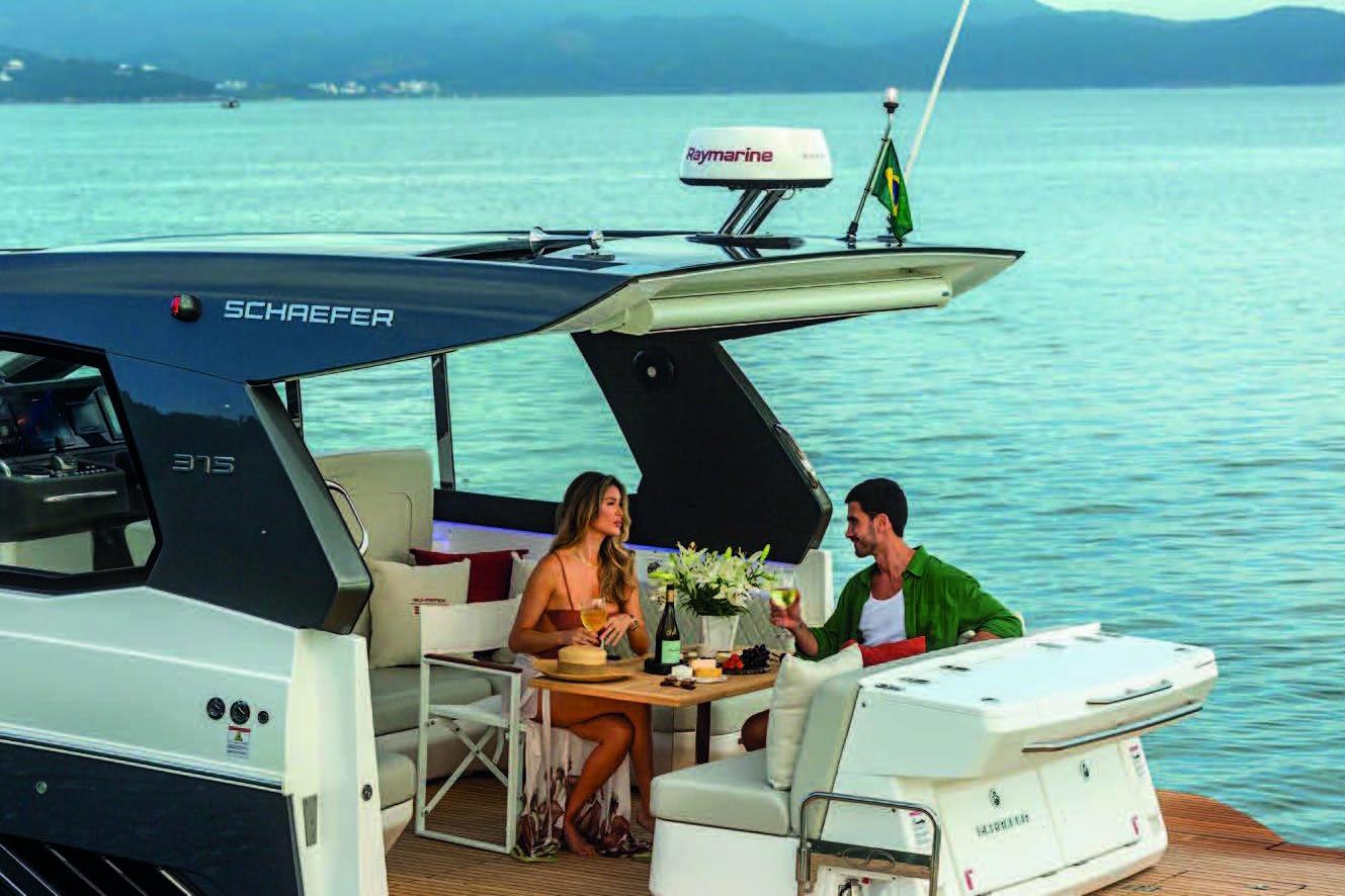 Couple enjoying a meal on a 2025 Schaefer 375 HT yacht, surrounded by serene waters.