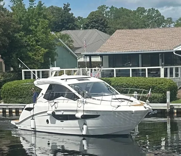  Yacht Photos Pics 2021 Sea Ray Sundancer 350 Coupe yacht docked near waterfront homes.