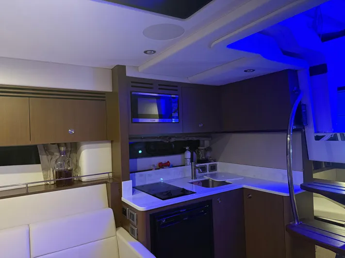  Yacht Photos Pics Luxurious interior of 2021 Sea Ray Sundancer 350 Coupe yacht with modern kitchen amenities.