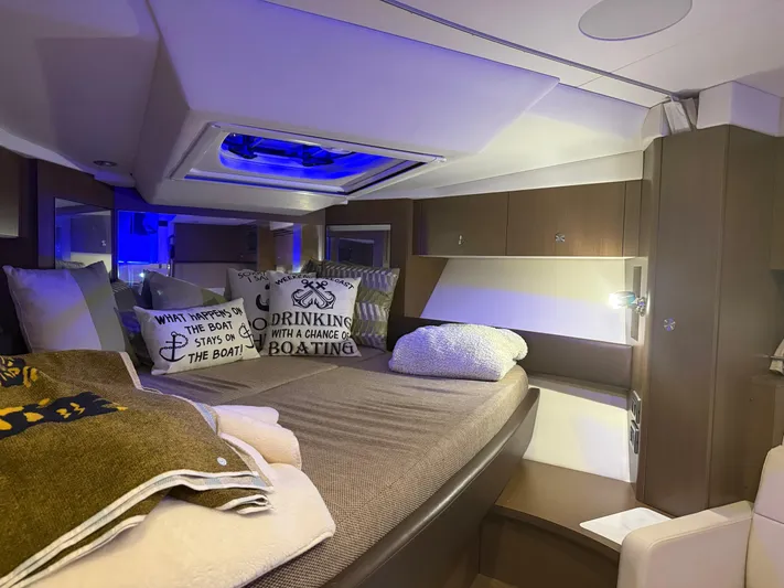  Yacht Photos Pics Luxurious interior cabin of 2021 Sea Ray Sundancer 350 Coupe with cozy bedding and ambient lighting.