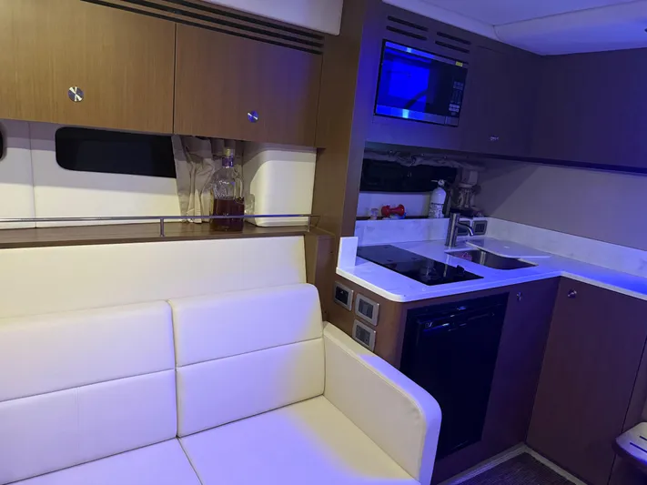  Yacht Photos Pics Interior of 2021 Sea Ray Sundancer 350 Coupe with modern kitchen and seating area.
