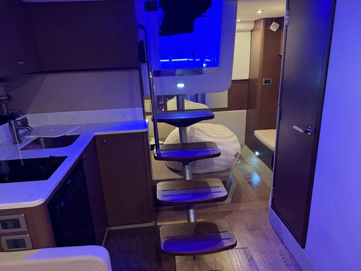  Yacht Photos Pics Interior of 2021 Sea Ray Sundancer 350 Coupe with modern kitchen and spiral staircase.