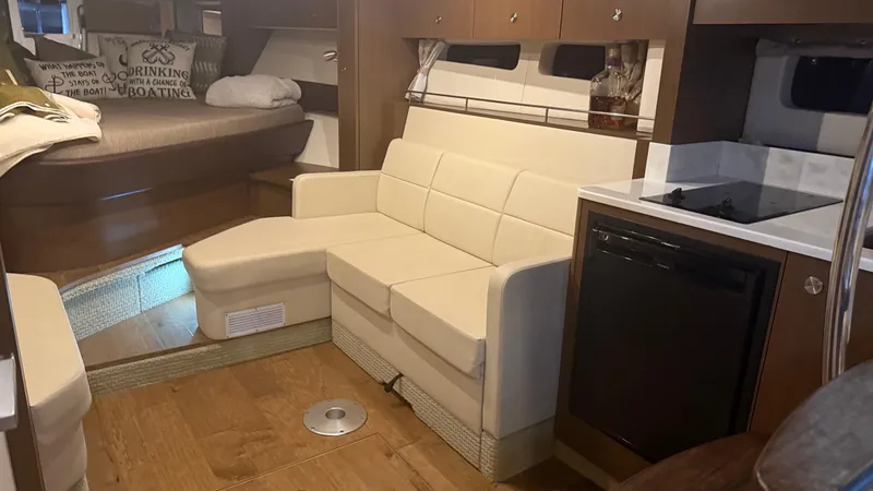  Yacht Photos Pics Interior of 2021 Sea Ray Sundancer 350 Coupe with modern seating and kitchenette.
