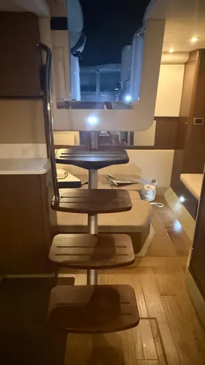  Yacht Photos Pics Interior of 2021 Sea Ray Sundancer 350 Coupe with wooden stairs and modern lighting.