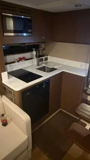  Yacht Photos Pics 2021 Sea Ray Sundancer 350 Coupe kitchen with modern appliances and sleek cabinetry.