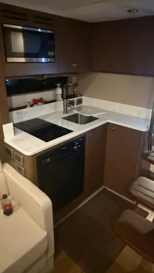  Yacht Photos Pics 2021 Sea Ray Sundancer 350 Coupe kitchen with modern appliances and sleek cabinetry.
