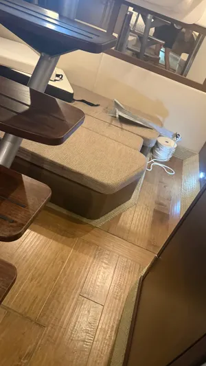  Yacht Photos Pics Interior of 2021 Sea Ray Sundancer 350 Coupe with wooden flooring and seating area.