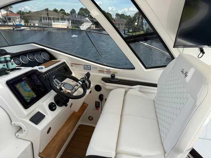  Yacht Photos Pics 2021 Sea Ray Sundancer 350 Coupe cockpit with modern navigation system and luxurious seating.