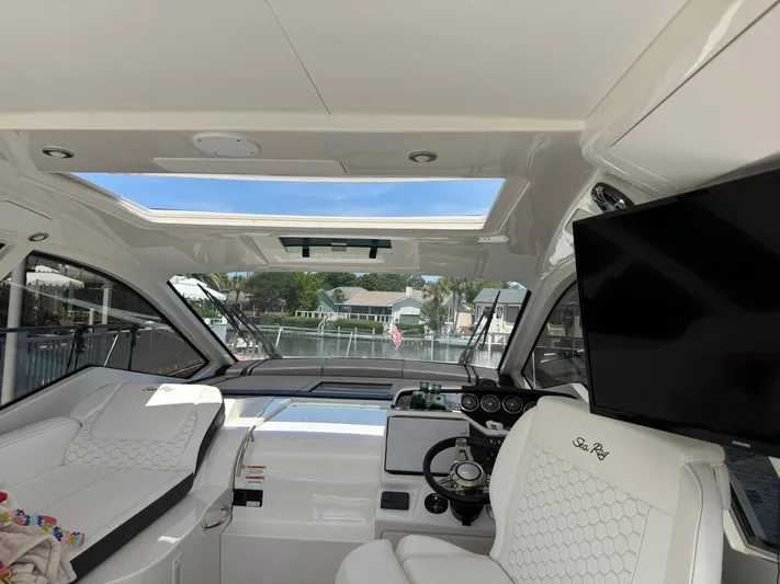  Yacht Photos Pics Interior of 2021 Sea Ray Sundancer 350 Coupe with panoramic windows and modern helm.