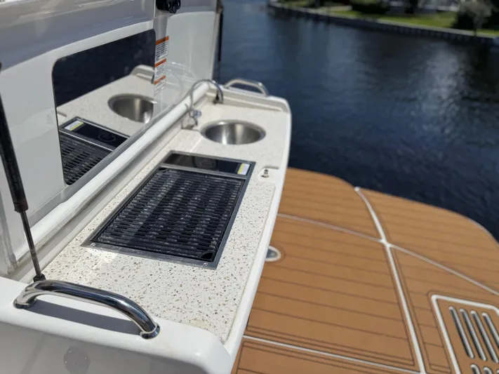  Yacht Photos Pics 2021 Sea Ray Sundancer 350 Coupe with outdoor kitchenette and water view.