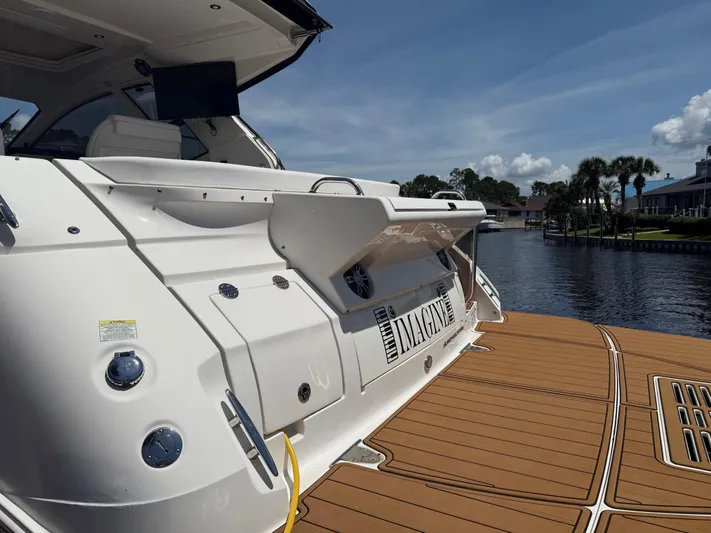  Yacht Photos Pics 2021 Sea Ray Sundancer 350 Coupe docked by a scenic waterfront.