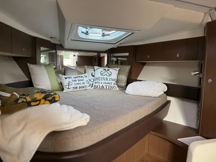  Yacht Photos Pics Interior cabin of 2021 Sea Ray Sundancer 350 Coupe with cozy bedding and decorative pillows.