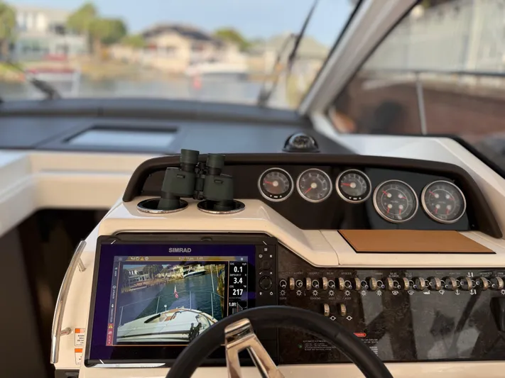  Yacht Photos Pics Helm of 2021 Sea Ray Sundancer 350 Coupe with navigation display and controls.