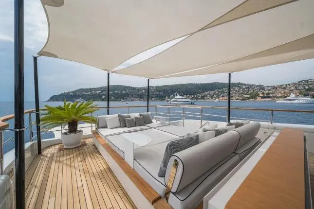  Yacht Photos Pics Luxurious 2023 Benetti Motopanfilo 37M yacht deck with elegant seating and scenic ocean view.