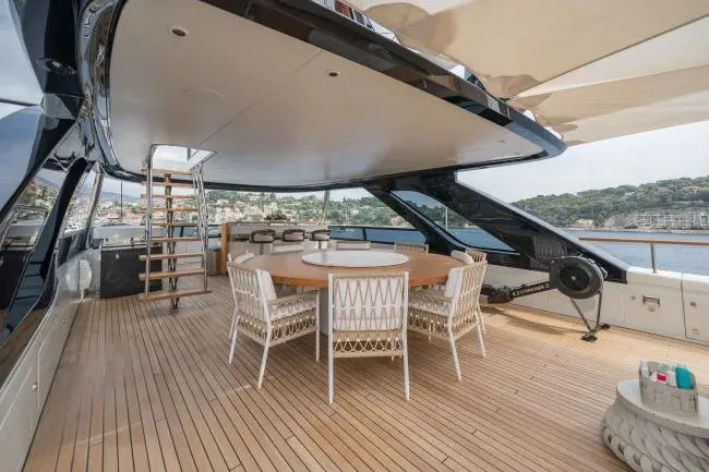  Yacht Photos Pics Luxurious 2023 Benetti Motopanfilo 37M yacht deck with elegant dining area and scenic views.