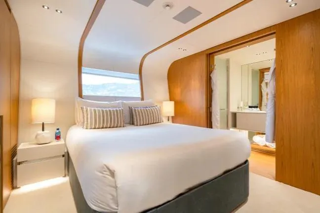  Yacht Photos Pics Luxurious bedroom in 2023 Benetti Motopanfilo 37M yacht with modern design and ensuite bathroom.