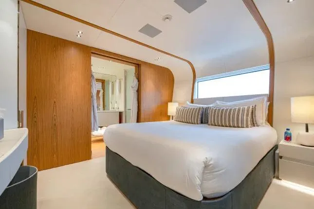  Yacht Photos Pics Luxurious bedroom interior on 2023 Benetti Motopanfilo 37M yacht, featuring modern design and elegant furnishings.