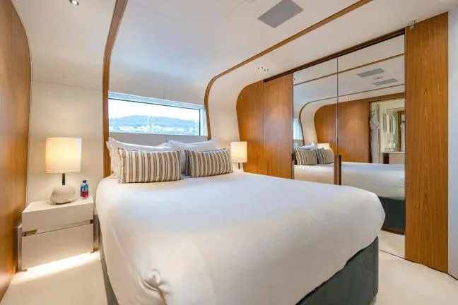  Yacht Photos Pics Luxurious bedroom interior on 2023 Benetti Motopanfilo 37M yacht, featuring elegant wood accents and modern design.