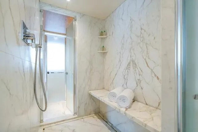 Yacht Photos Pics Luxurious marble bathroom in 2023 Benetti Motopanfilo 37M yacht, featuring a modern shower.