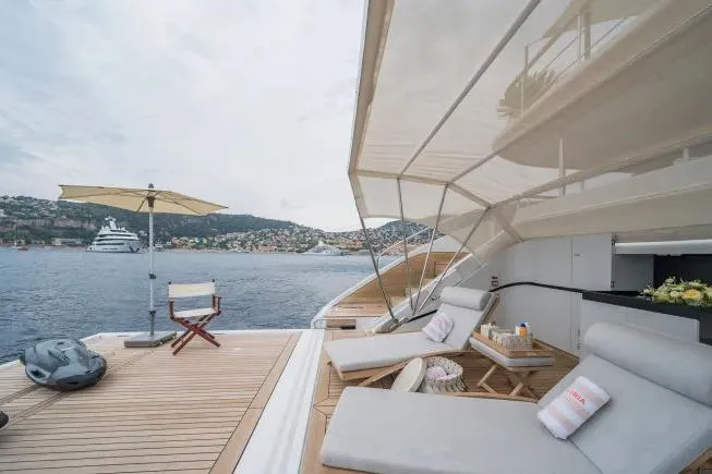  Yacht Photos Pics Luxurious 2023 Benetti Motopanfilo 37M yacht deck with sun loungers and scenic ocean view.