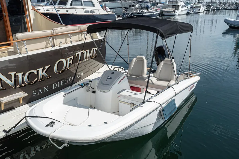 Nick Of Time Yacht Photos Pics 2007 Midnight Lace Sport Cruiser docked beside a larger boat in a marina.
