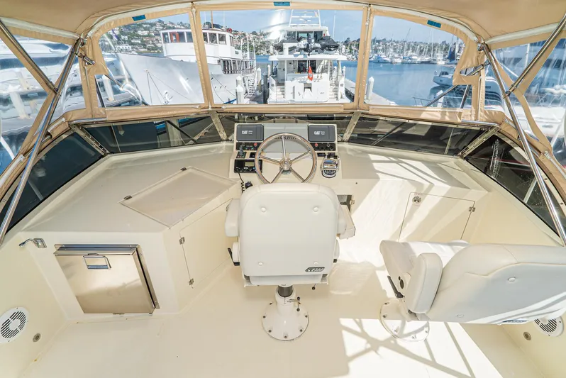 Nick Of Time Yacht Photos Pics 2007 Midnight Lace Sport Cruiser helm with dual seats and marina view.