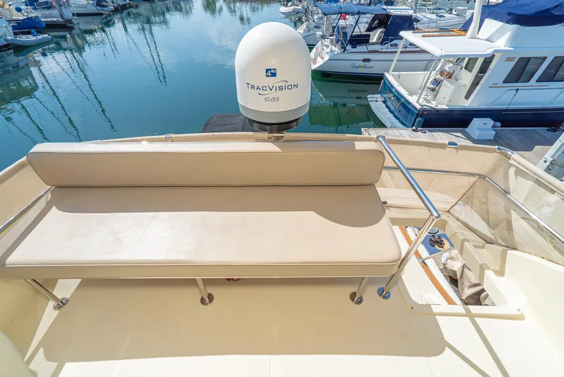 Nick Of Time Yacht Photos Pics 2007 Midnight Lace Sport Cruiser with seating area and TracVision satellite, docked at marina.