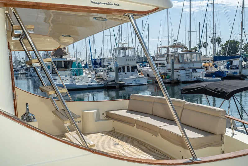 Nick Of Time Yacht Photos Pics 2007 Midnight Lace Sport Cruiser yacht docked in a marina, featuring elegant seating and sleek design.