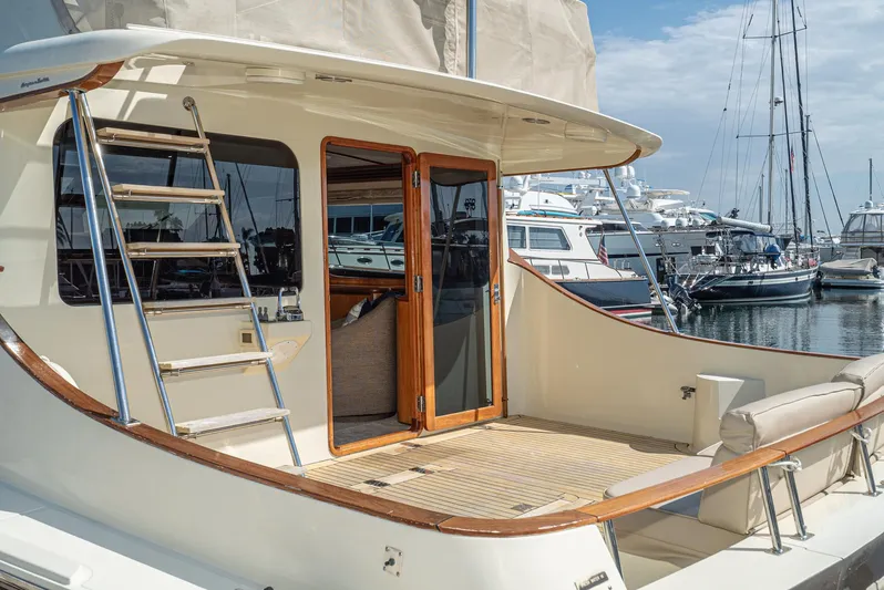 Nick Of Time Yacht Photos Pics 2007 Midnight Lace Sport Cruiser yacht docked at marina, featuring elegant deck and ladder.